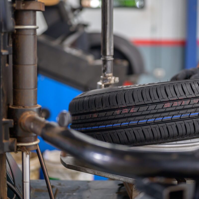 Car mechanic changing tire